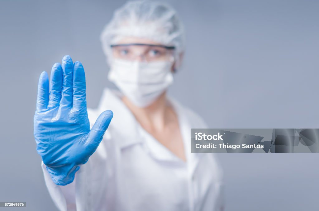 Great concept of infection Great concept of infection, contamination, doctor making stop sign with his hand. Danger Stock Photo