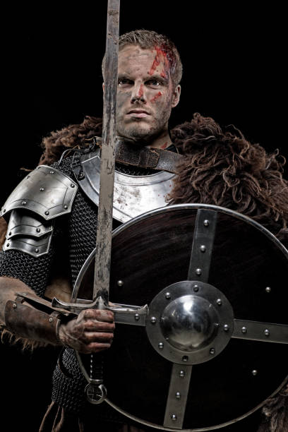 istock Weapon wielding dirty bloody viking warrior in emotional pose 872850006