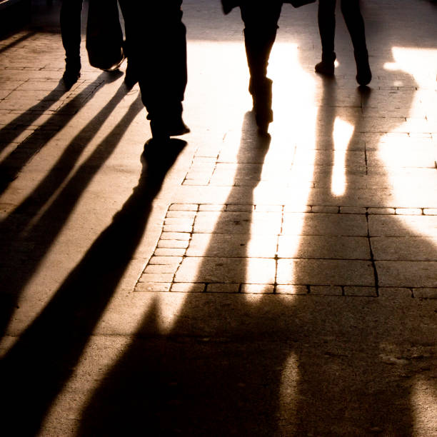 istock Shadow and silhouette of people on the sidewalk 872850042