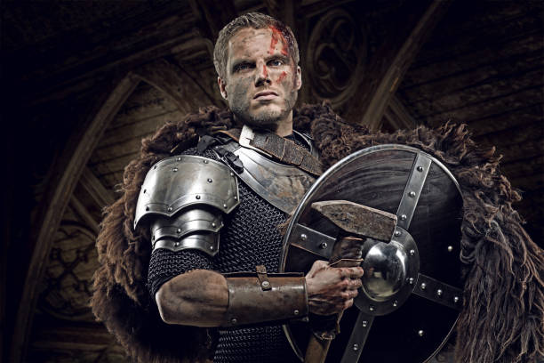 istock Weapon wielding dirty bloody viking warrior in emotional pose 872852596