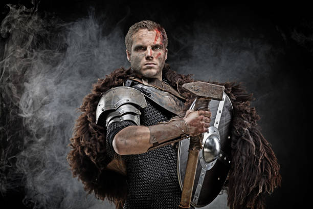 istock Weapon wielding dirty bloody viking warrior in emotional pose 872852674