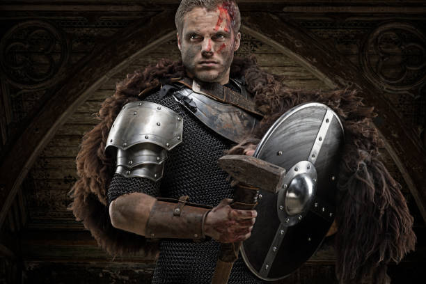istock Weapon wielding dirty bloody viking warrior in emotional pose 872852696