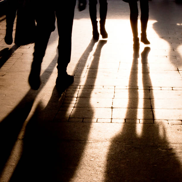 istock Shadow and silhouette of people on the sidewalk 872852836