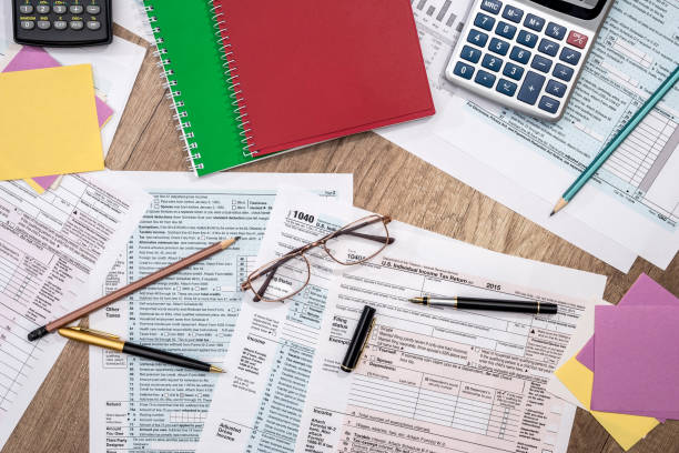 istock tax form with notepad, pen, pencil and calculator 872853974