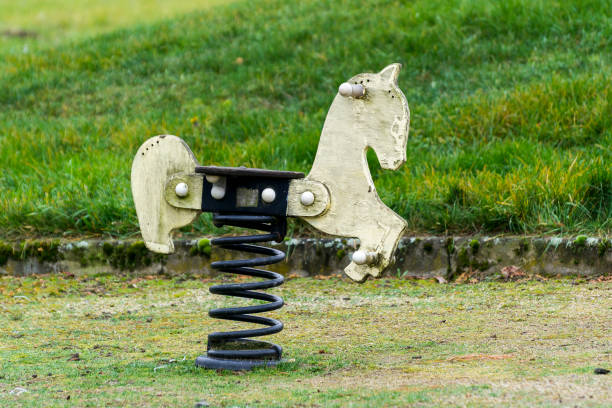 Asian little girl sitting on the rocking horse