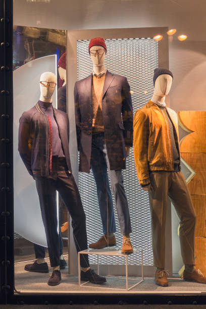 istock Men's dummies in the store window and city reflections 872869624