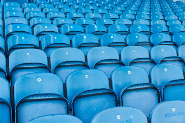 istock rows of blue plastic seats in a stadium 872870202