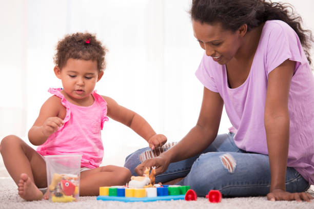 istock Mother and daughter playing educational game. 872870438