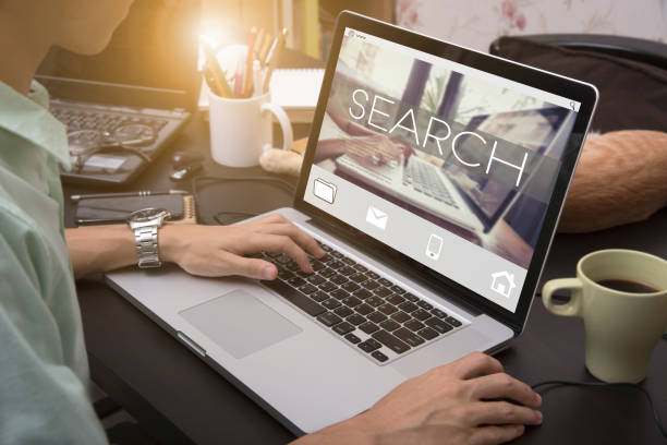 istock business hand typing on a laptop keyboard with Search homepage on the computer screen searching exploration discover inspect finding concept. 872873106