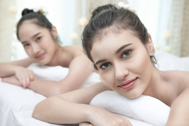 istock Two beautiful women lying on the bed. 872873690