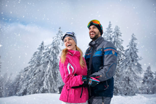 istock Beautiful smiling couple enjoying in winter vacations 872874706