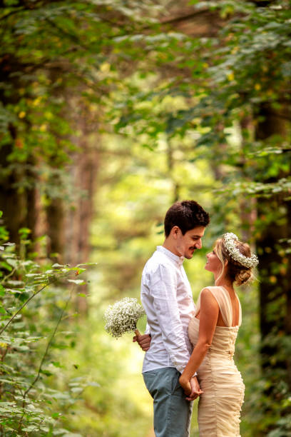istock Happy newlyweds standing in the park 872878312