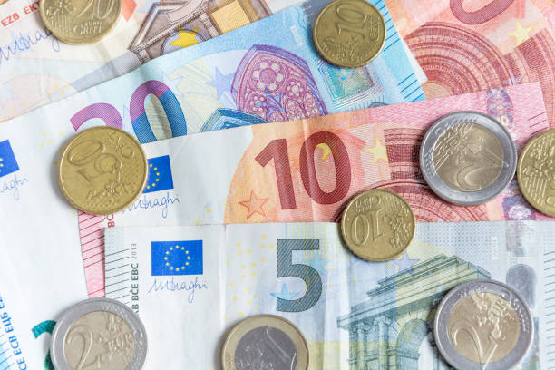 istock Euro bank notes and coins close up as a background 872878534