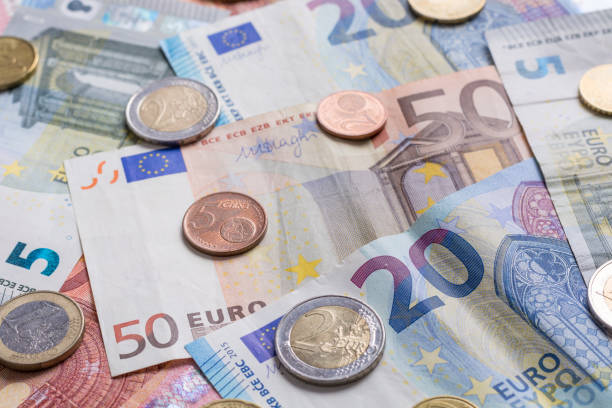 istock Euro bank notes and coins close up as a background 872880940