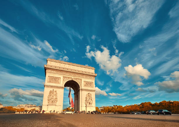 istock Arc de Triumph in Paris with beautiful clouds behind in Fall 872892126