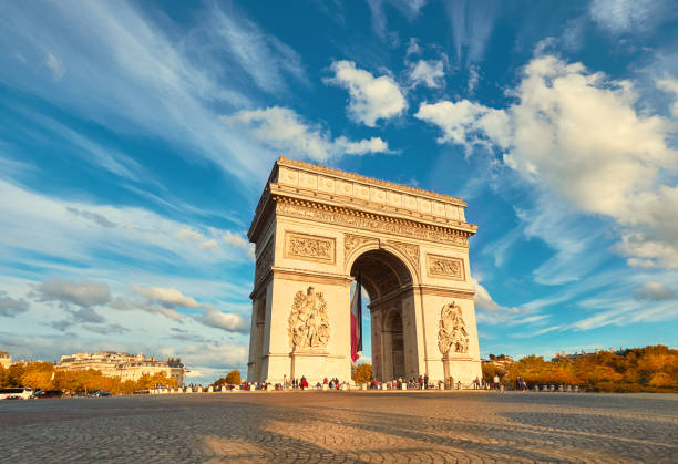 istock Arc de Triumph in Paris with beautiful clouds behind in Fall 872892128