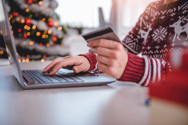 mujeres de compras online en navidad - unrecognizable person laptop holding women fotografías e imágenes de stock