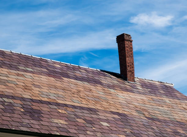 istock Old Leaning Brick Chimney on a Slate Roof 872904338