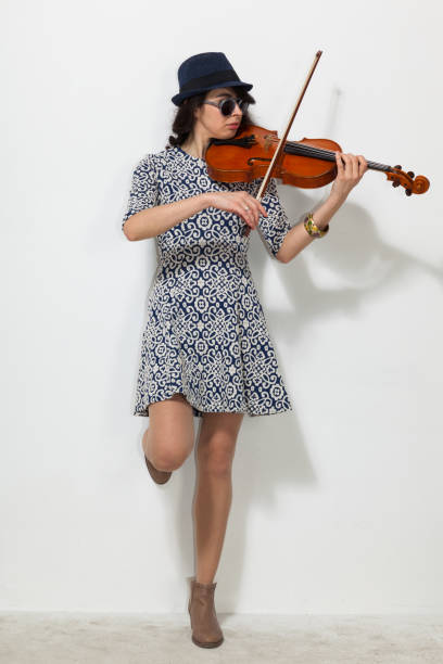 istock Young woman with dark glasses and a violin 872905244