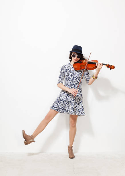 istock Woman with musical instrument 872905400