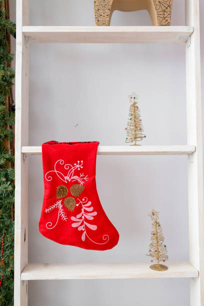 istock red christmas sock hanged above white stairs in room 872907668