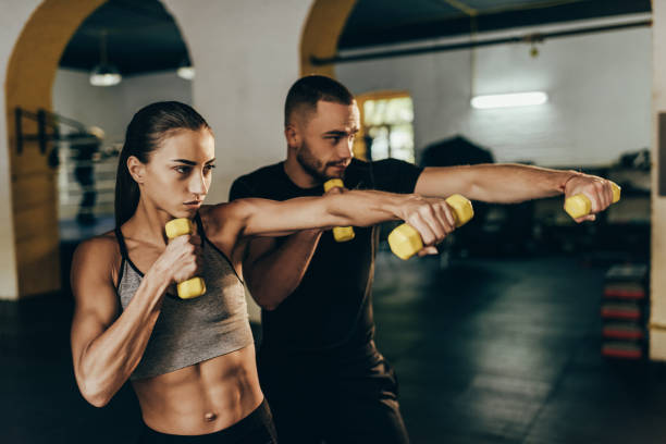 istock athletic couple exercising with dumbbells 872916828