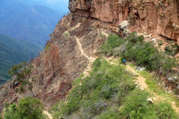 istock Mountain biker riding dangerous trail down to Chicamocha Canyon, Colombia 872919956
