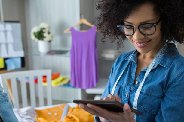 istock Female fashion designer using digital tablet 872923346