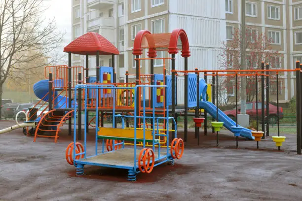 Photo of Children's playground on foggy autumn morning