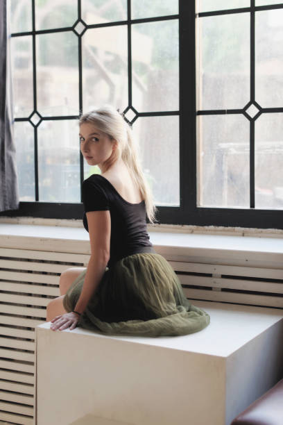 istock Ballerina sitting near window 872928112