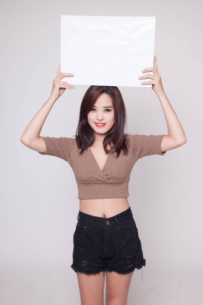 istock Young Asian woman with white blank sign. 872931284