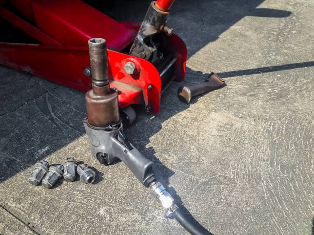 istock pneumatic wrench with car tire nuts 872931510