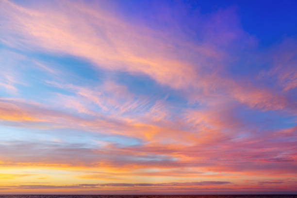 istock Beautiful evening sky with pink clouds. Sunset over the sea 872934386