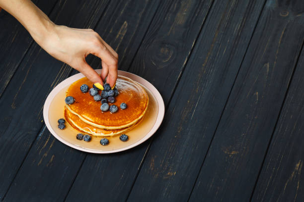 istock Preparing Pancakes with Blueberries and Honey 872937606