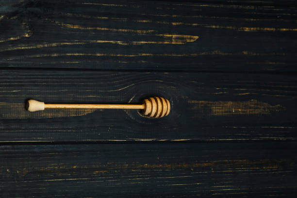 istock spoon for honey on dark wood background 872937740