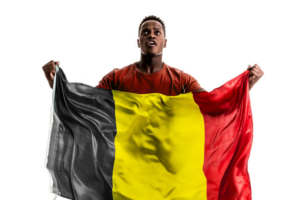 istock Belgian afro fan holding the national flag 872939076