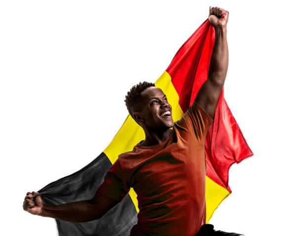 istock Belgian afro fan holding the national flag 872939084