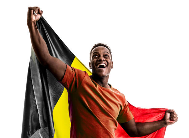 istock Belgian afro fan holding the national flag 872939098