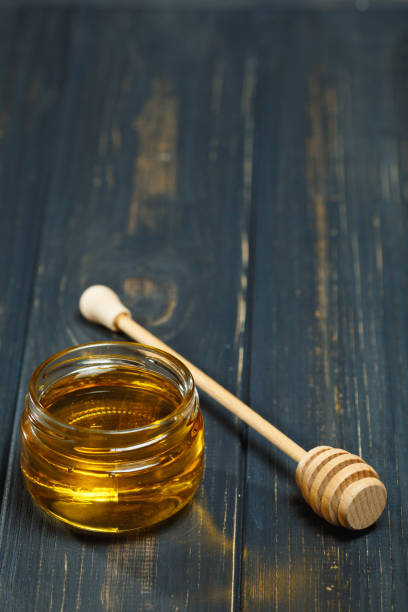 istock Jar of Honey on Wood Table Still Life 872939874