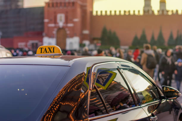 taxi to the center of the city on a busy street with many people and reflected in the glass evening lights of metropolis Moscow stock photo