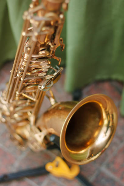 istock Golden saxophone staying on the rack 872950454