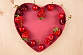 Red berries for Valentine's Day in heart-shaped box