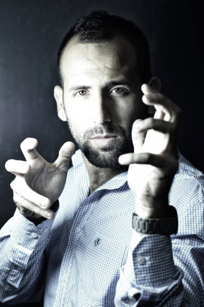 istock Stylish handsome bearded man in trendy suit on black background 872953444