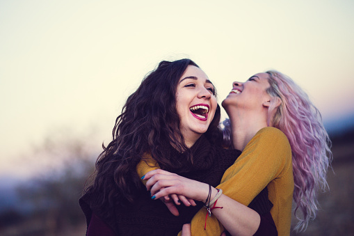 Beautiful Girls Laughing And Embracing Each Other In Nature