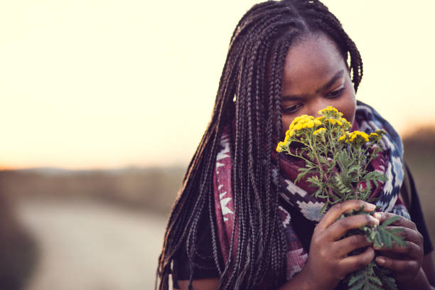 istock Girl Smelling Flowers 872956528