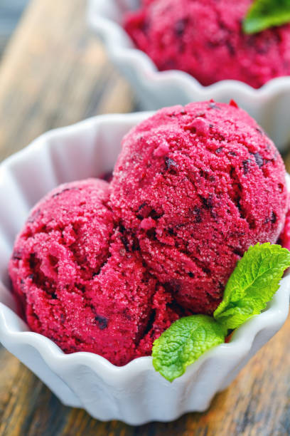 istock Homemade berry ice cream in a white ceramic cup. 872957480