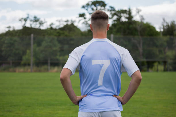 istock Football player standing with hand on hips in ground 872961338