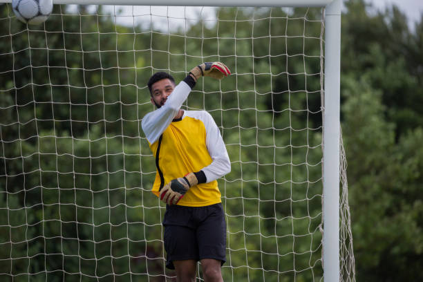 istock Goalkeeper standing near goal post 872966084