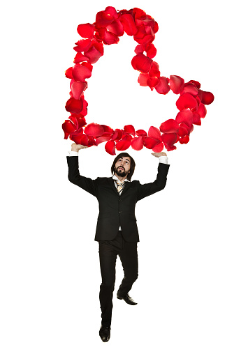 Young businessman with big rose heart in hands