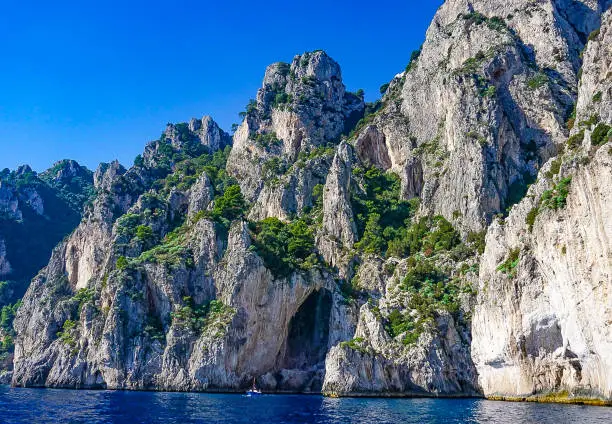 The White Grotto of the island of Capri, Italy.  Coastal Rocks on the Mediterranean Sea at Capri Island from a motor boat tour.